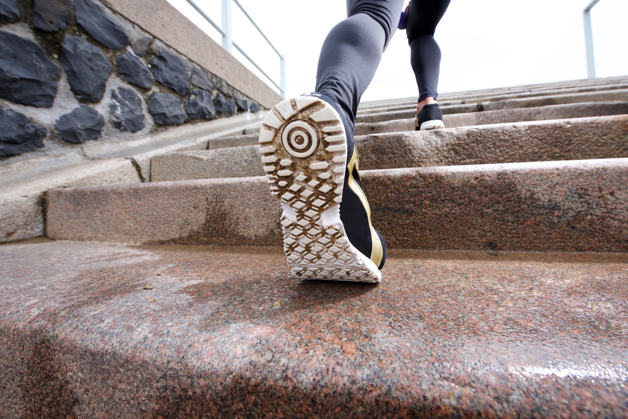 Female runner in action on staircase