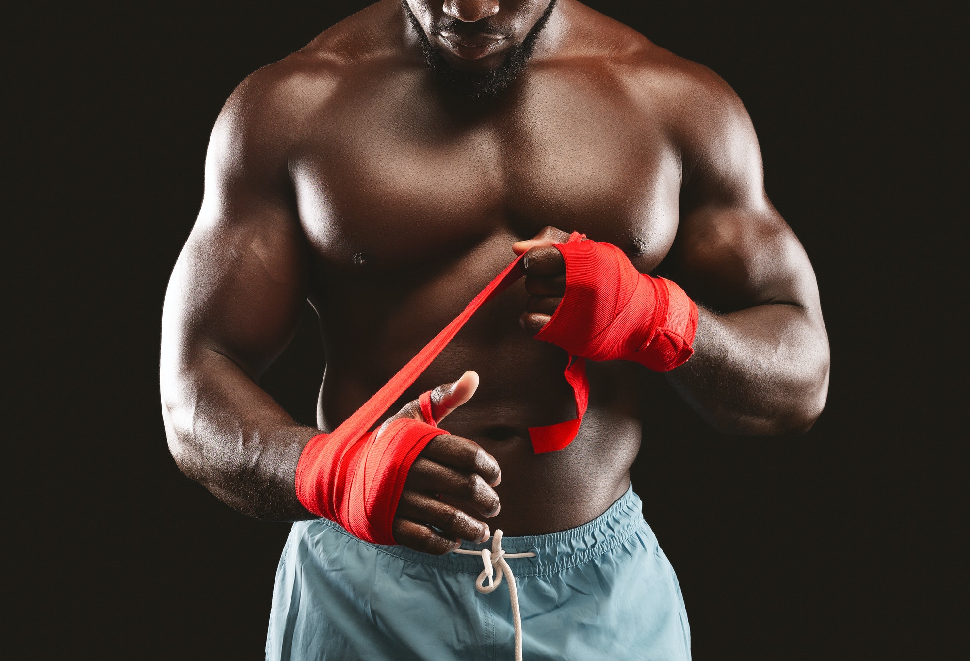 black man wrapping wrists for hanging abs exercise